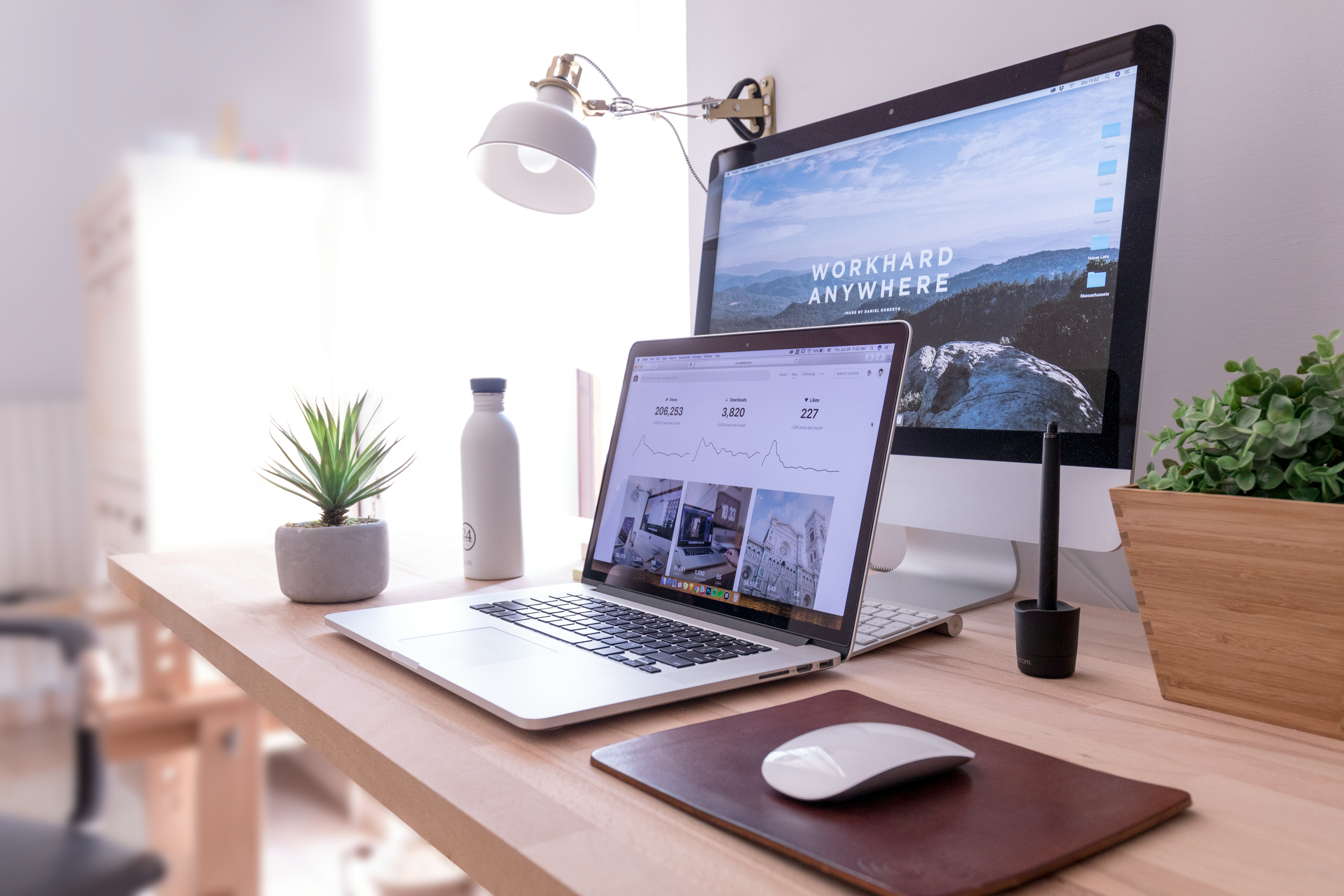 Laptop and monitor on a bright desk